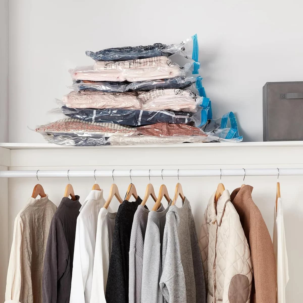compressed vacuum storage bags stacked on a closet shelf
