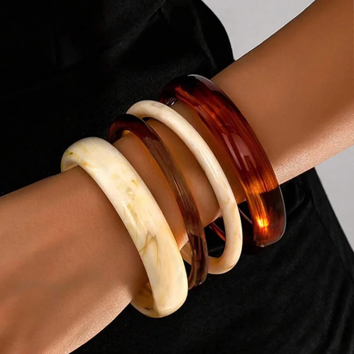 chunky resin bangles stacked on the wrist, product photo
