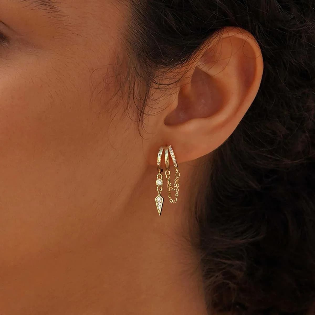 side view of the gold dangle huggie earrings, product photo