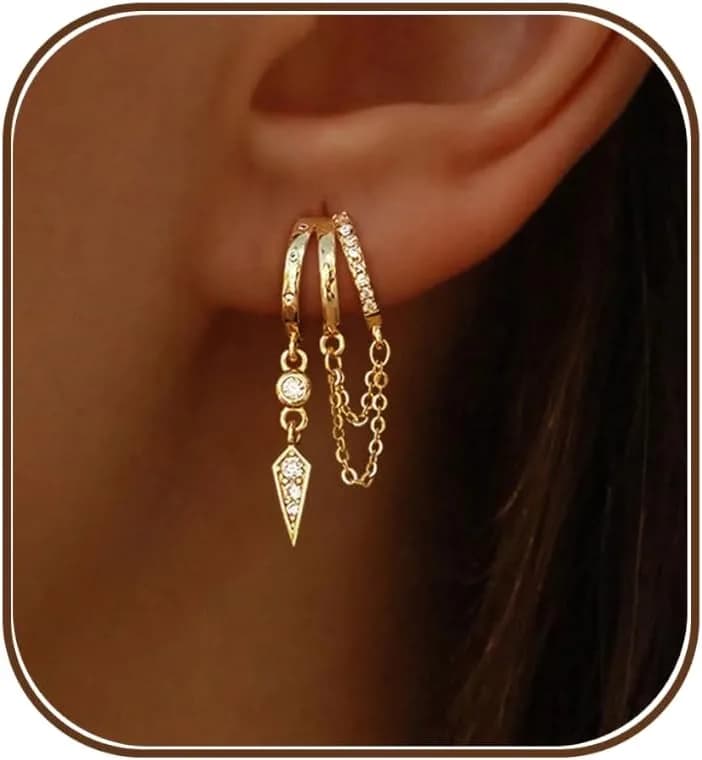 gold dangle huggie earrings worn on the ear